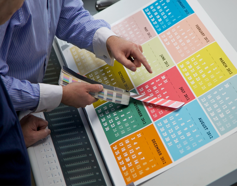 Printed calendar being checked for color accuracy.