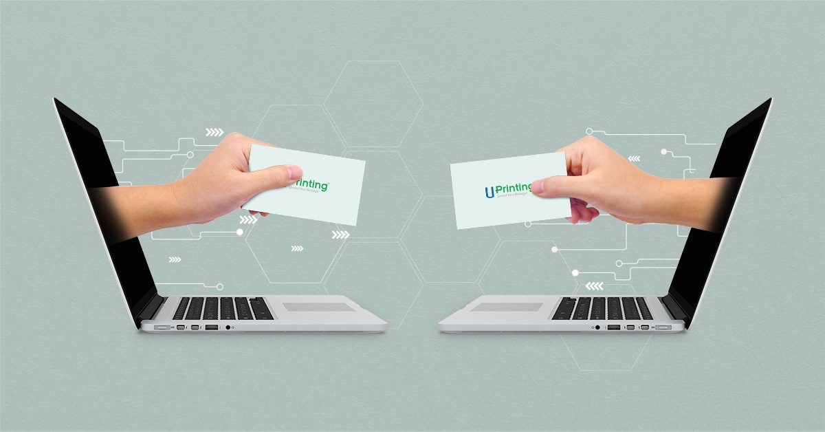 Exchanging business cards via laptops.